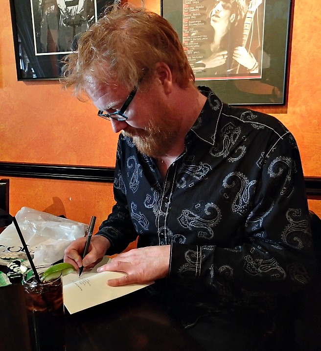 George Murray signs a copy of his book Whiteout.
