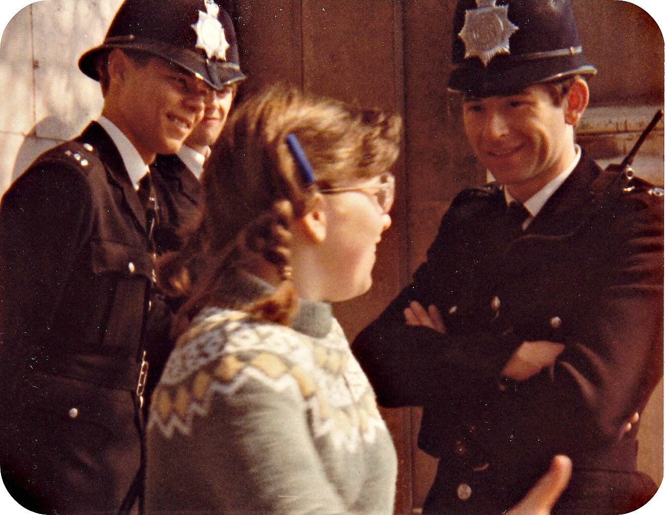 Annette sweet talking the Bobbies to pose for a photo with her during a short stop in London en route to Spain